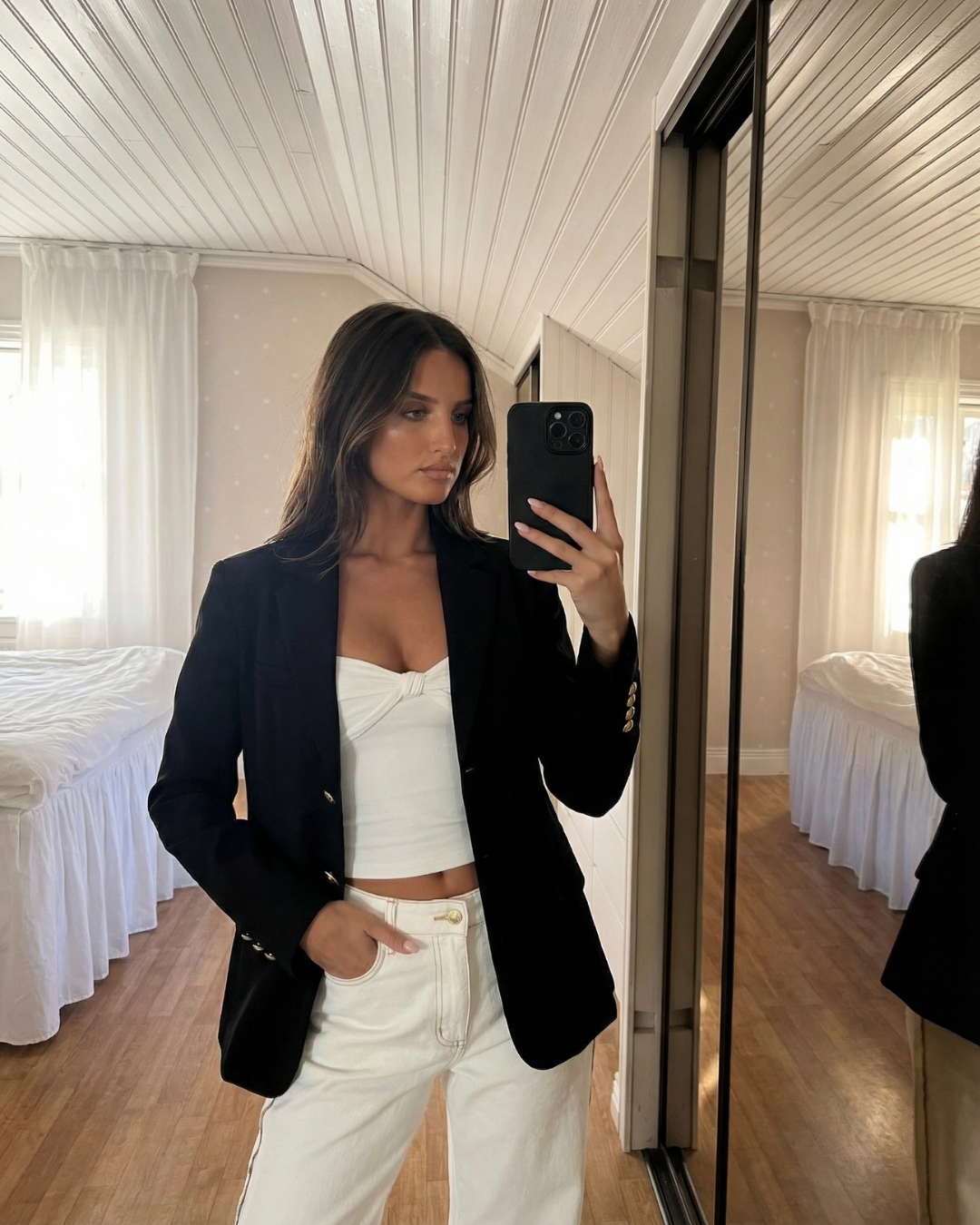 Chic women's tailored blazer, featuring classic gold buttons. Structured elegant outerwear for a smart and professional look.