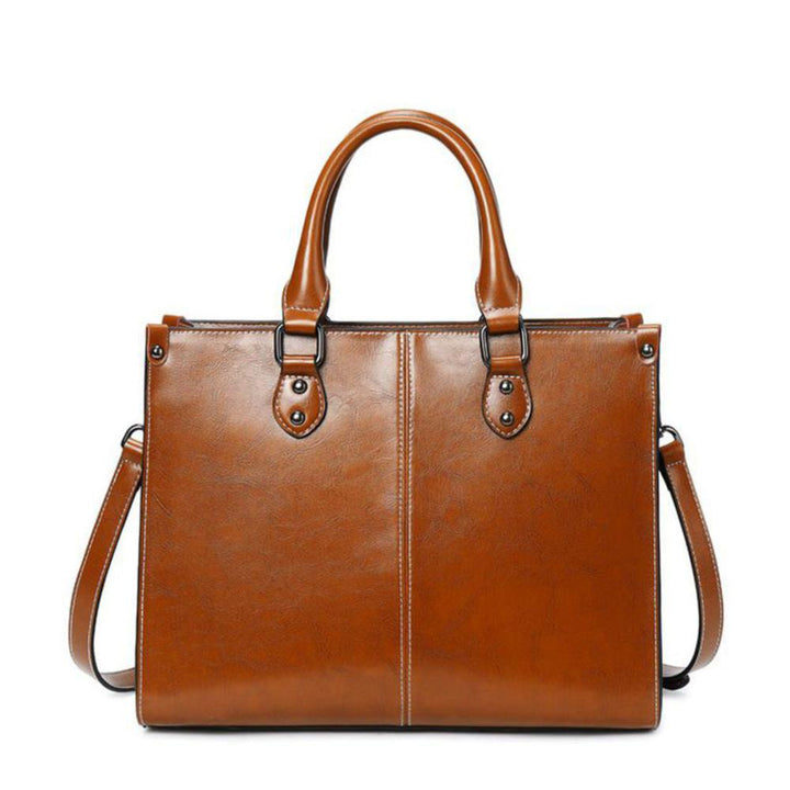 Elegant women's leather tote handbag with zipper closure, perfect for daily use & shoulder carry.
