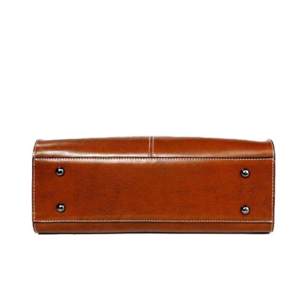 Chic women's leather tote handbag with secure zipper, an elegant and practical everyday shoulder bag.