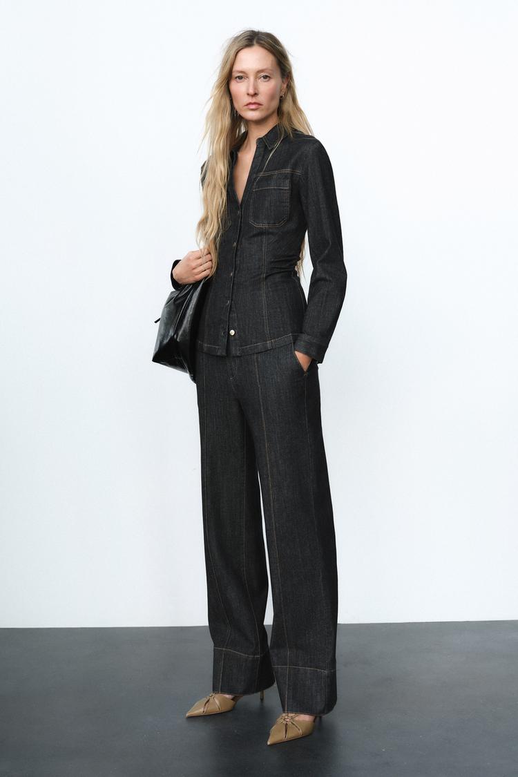 Fashionable women's fitted denim top and trousers set in blue, offering a complete trendy and versatile spring/summer outfit.