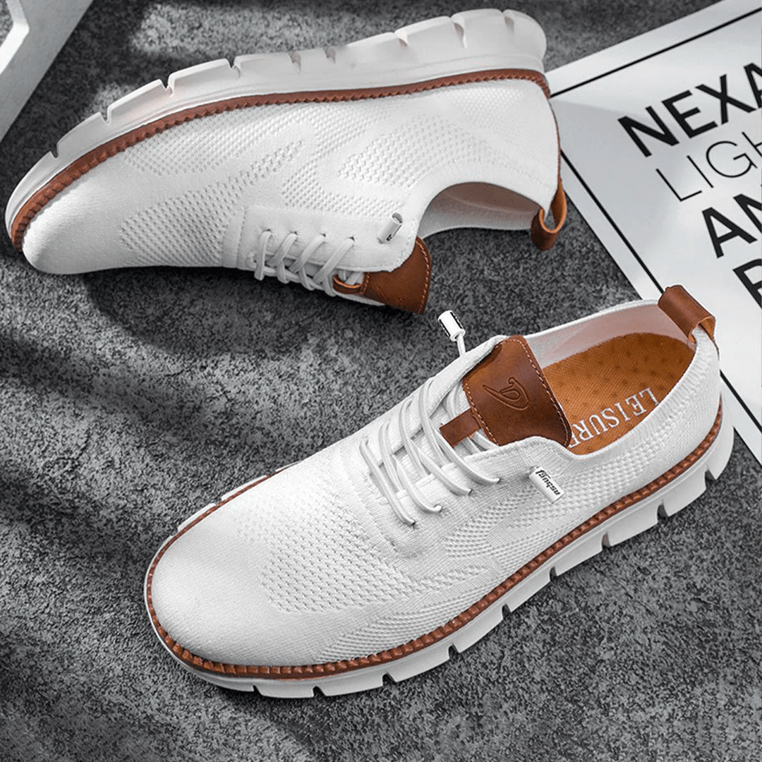 Fashionable men's lace-up sneakers, black with perforated upper, perfect for casual outfits.