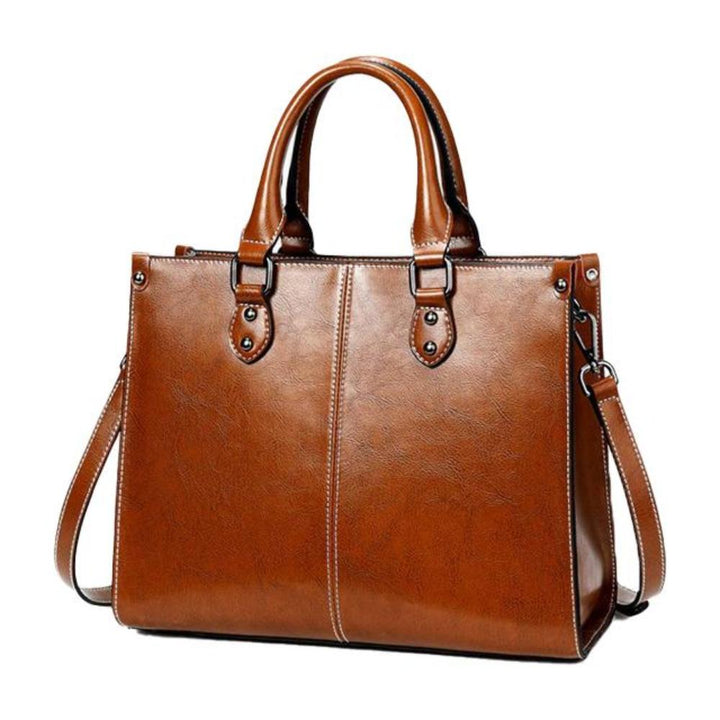 Women's elegant leather tote handbag with secure zipper and internal organizer pockets, a functional shoulder bag.