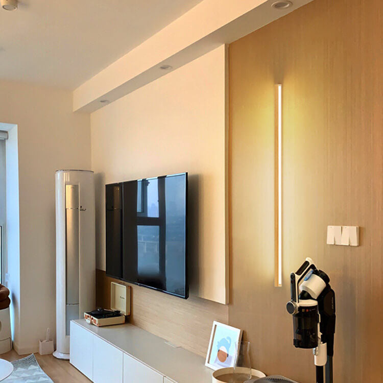 Natural wood wall lamp providing gentle ambient lighting, ideal for a cozy, modern home.