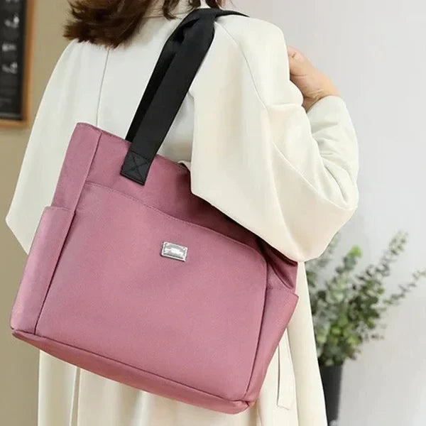 Women's travel shoulder bag, lightweight & waterproof. Ideal for essentials, durable construction.