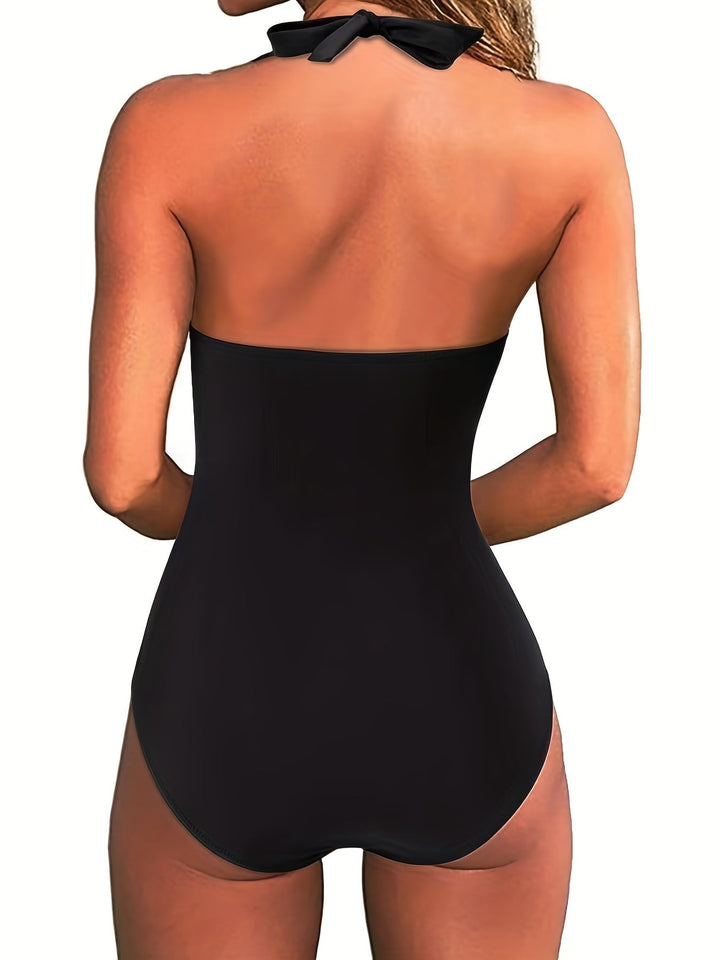 Elegant women's one-piece swimsuit featuring a halter-neck, V-neck, and vibrant print. Summer beachwear.