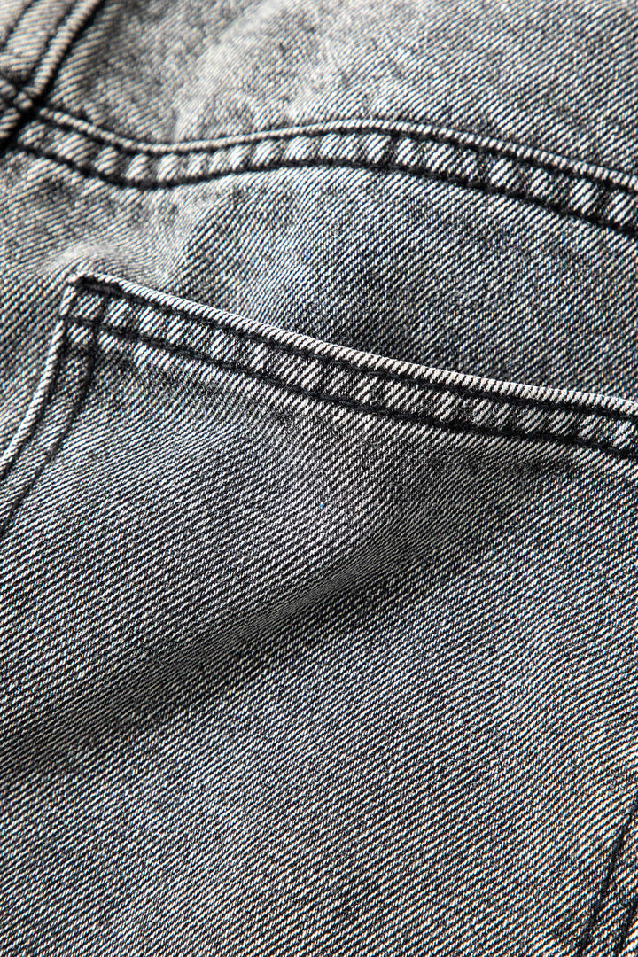 Modern women's high-waisted straight-leg jeans with a distinct asymmetric design. Light wash, comfortable, trendy.