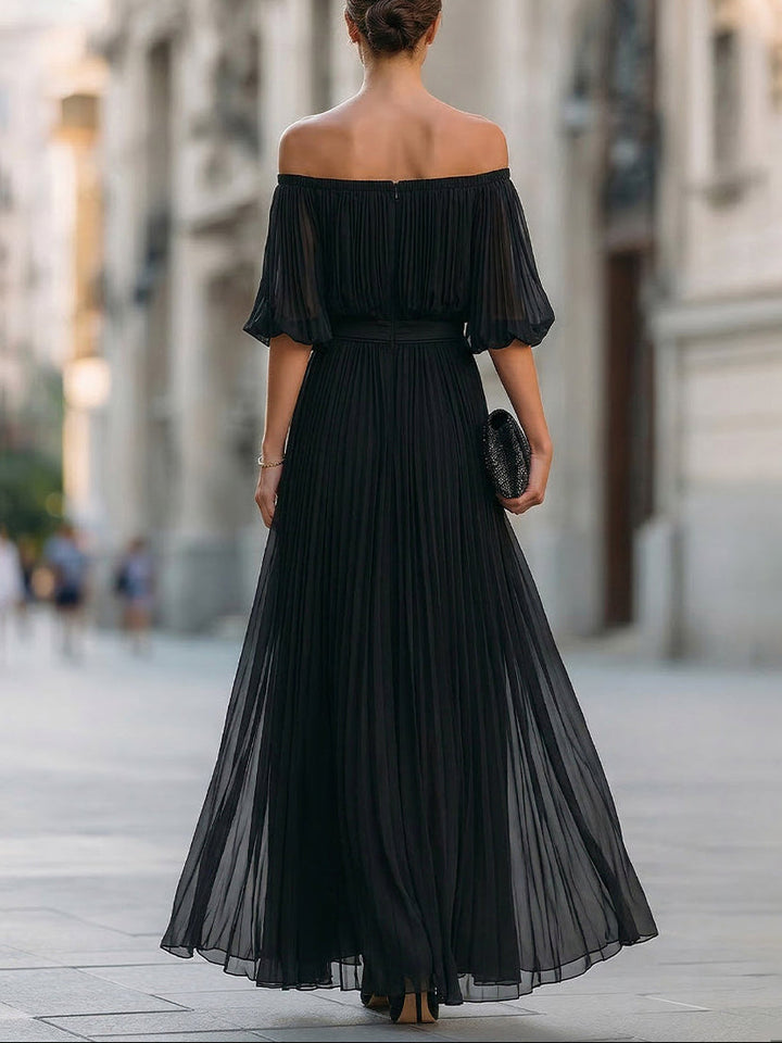 Women's sophisticated black off-shoulder maxi dress with a flowing pleated skirt, ideal for parties.
