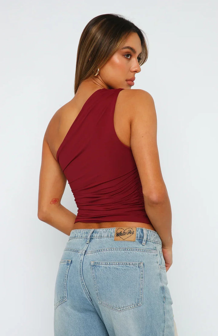 Trendy women's crop top: burgundy, ruched, one-shoulder design for chic evening wear.