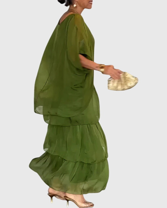 Plus size women's long flowing maxi dress, offering timeless style, comfort, & elegance.