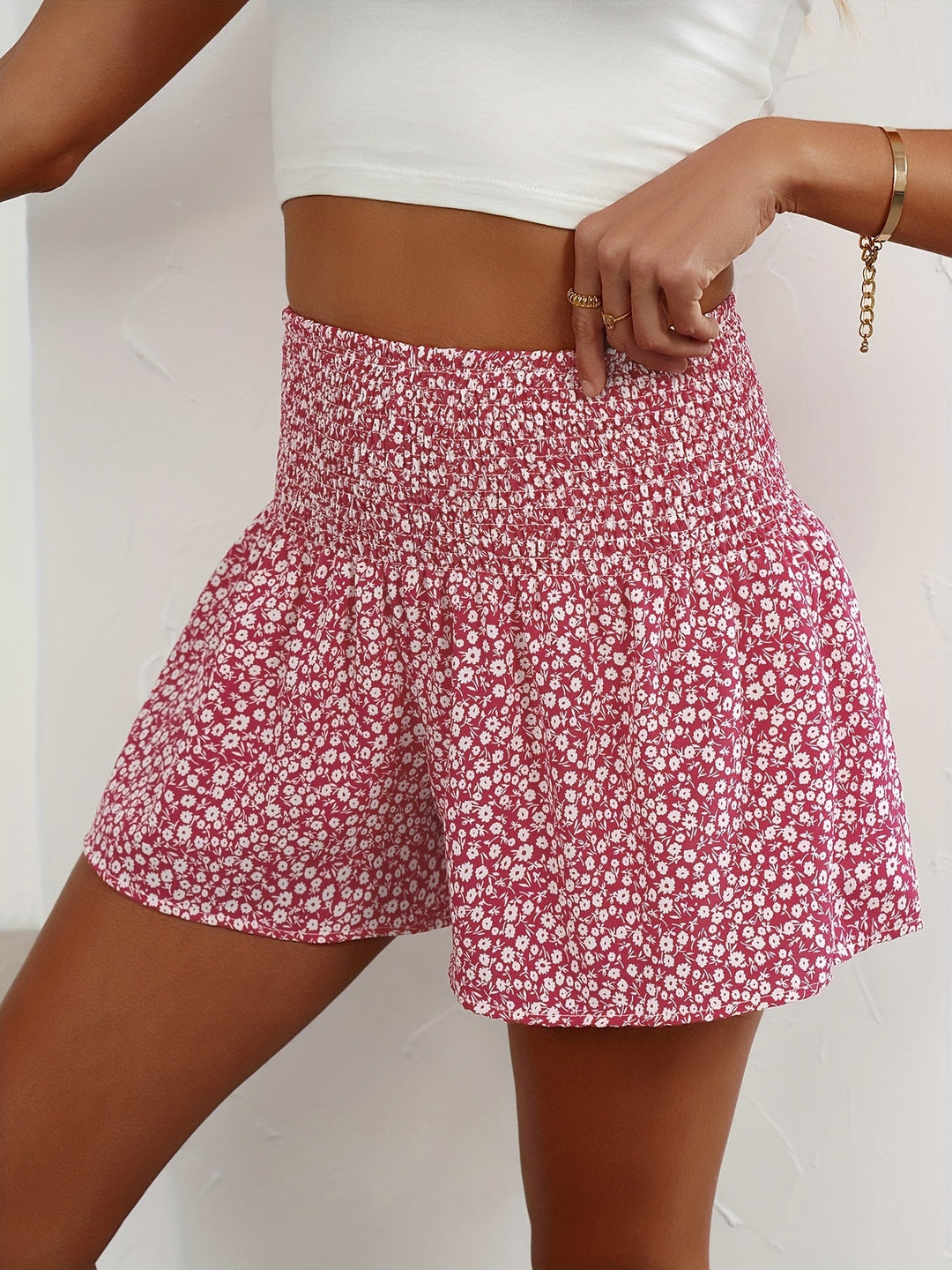 Lightweight ladies' summer shorts featuring a vibrant floral print & stretchy elastic waist for comfort.