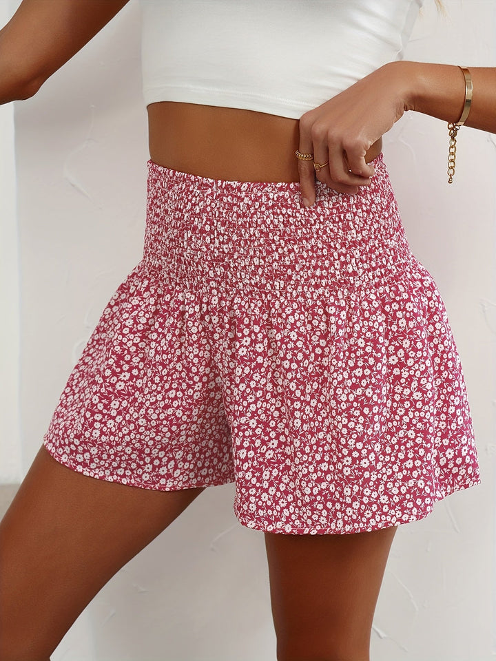 Lightweight ladies' summer shorts featuring a vibrant floral print & stretchy elastic waist for comfort.