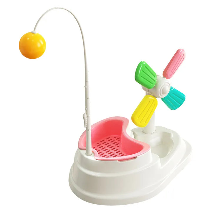 Happy cat batting an interactive windmill toy, stimulating mental focus & physical activity for pet fun.