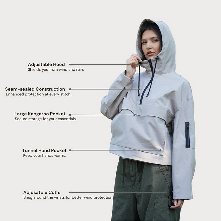 Woman hiking in a forest, wearing a stylish, all-season waterproof adventure jacket.