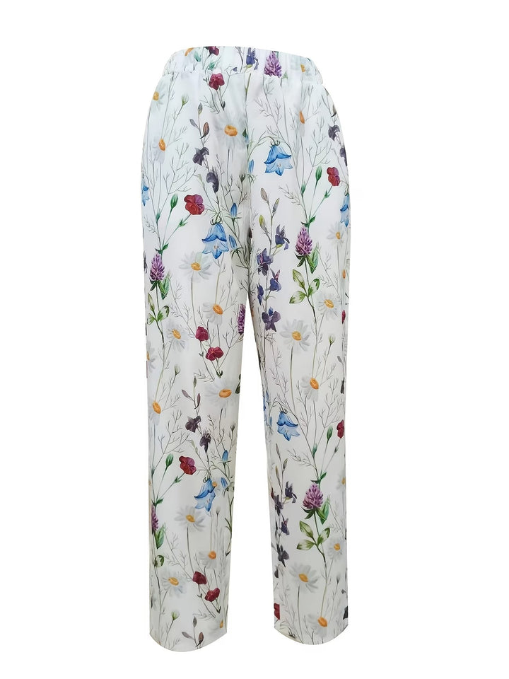 Comfortable women's flowing floral summer trousers. Lightweight, breathable white pants with a relaxed fit for casual elegance.