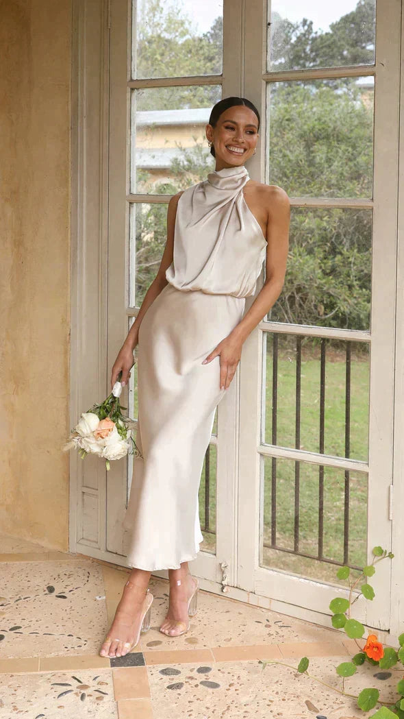 Woman wearing elegant versatile midi dress, styled perfectly for a party or special occasion.
