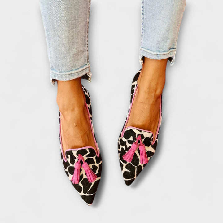 Stylish women's animal print tassel loafers, perfect slip-on shoes for casual or dressy outfits.