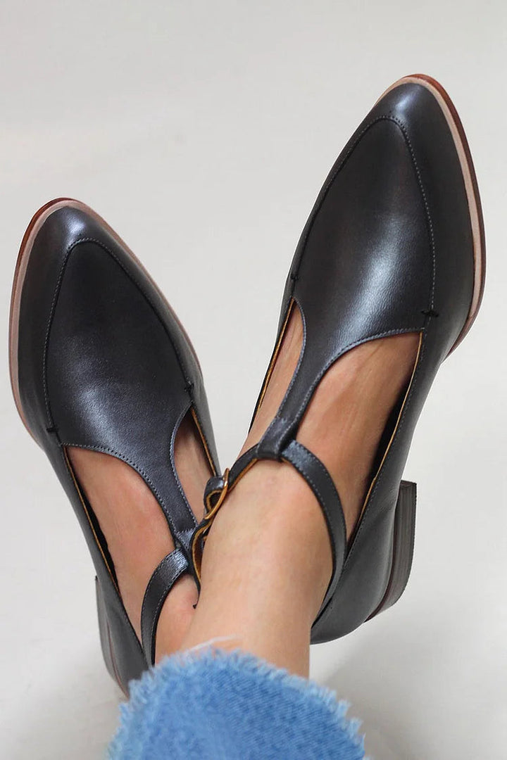 Elegant black T-bar women's dress shoes with pointed toe, ideal for office wear & special occasions. Classic comfort.
