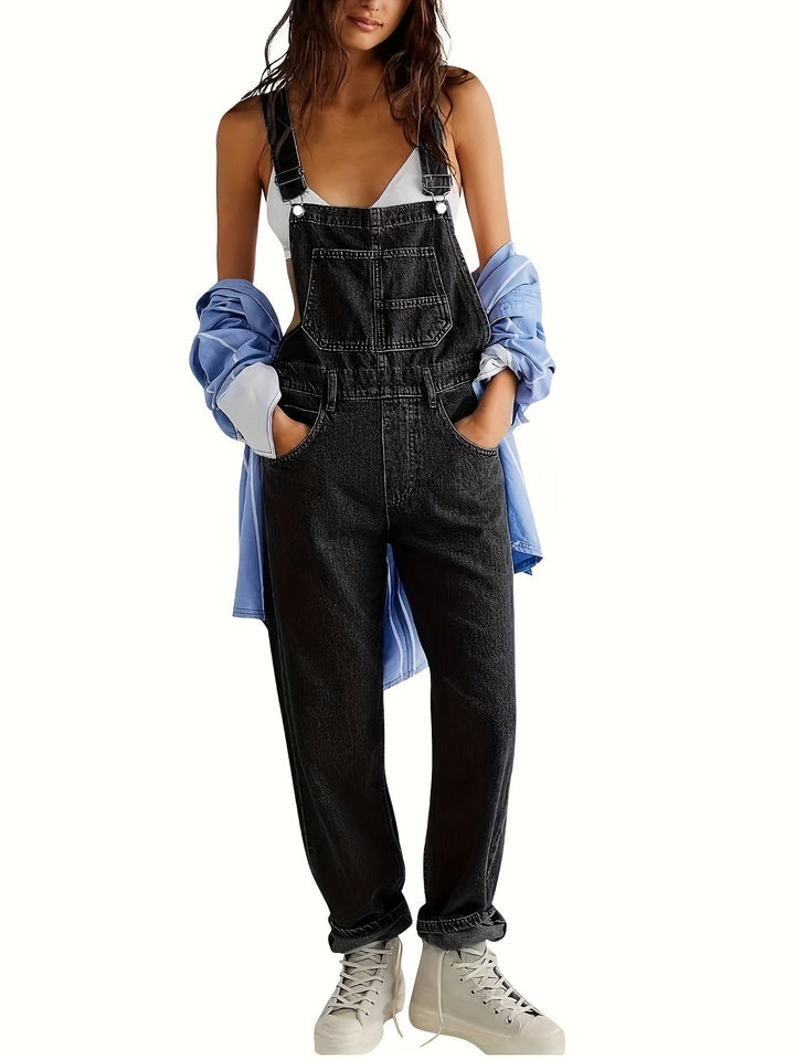 Adjustable straps detail on women's loose fit denim dungarees, comfortable and versatile design.