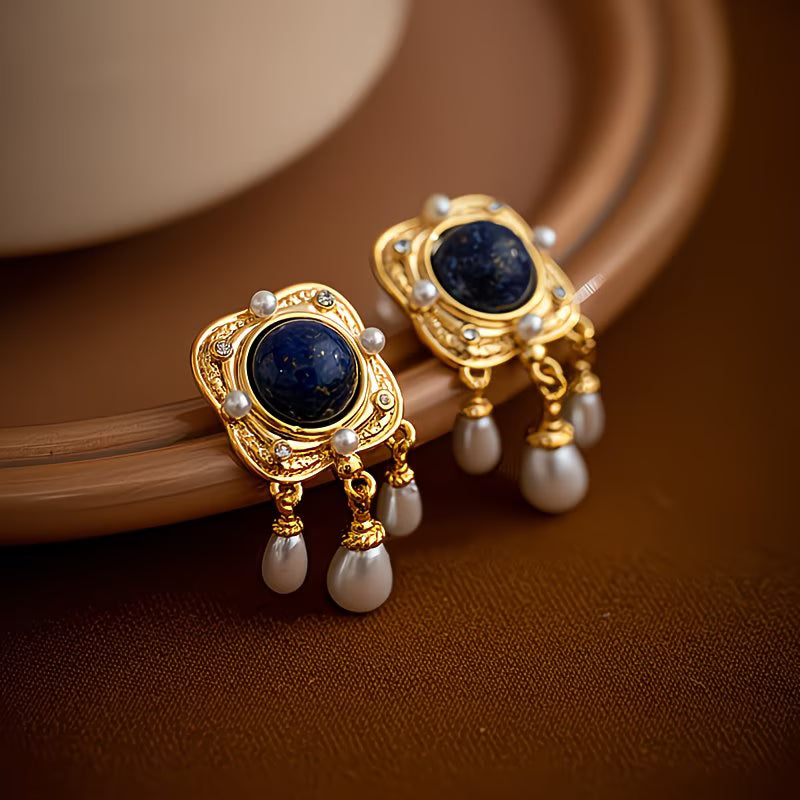 Close-up of sparkling royal blue pearl chandelier earrings. Elegant women's drop jewelry with hypoallergenic posts.