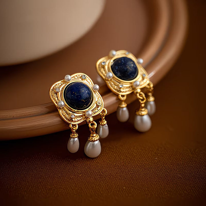 Close-up of sparkling royal blue pearl chandelier earrings. Elegant women's drop jewelry with hypoallergenic posts.