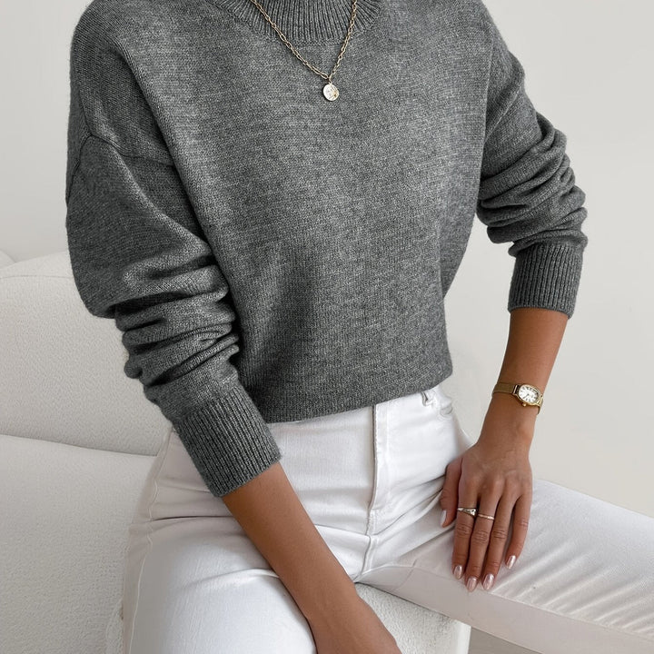 Knitted women's pullover with high neck, a versatile autumn winter piece.
