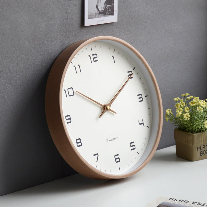 Clear face minimalist silent wall clock with elegant wooden frame. Modern design for sophisticated home offices.