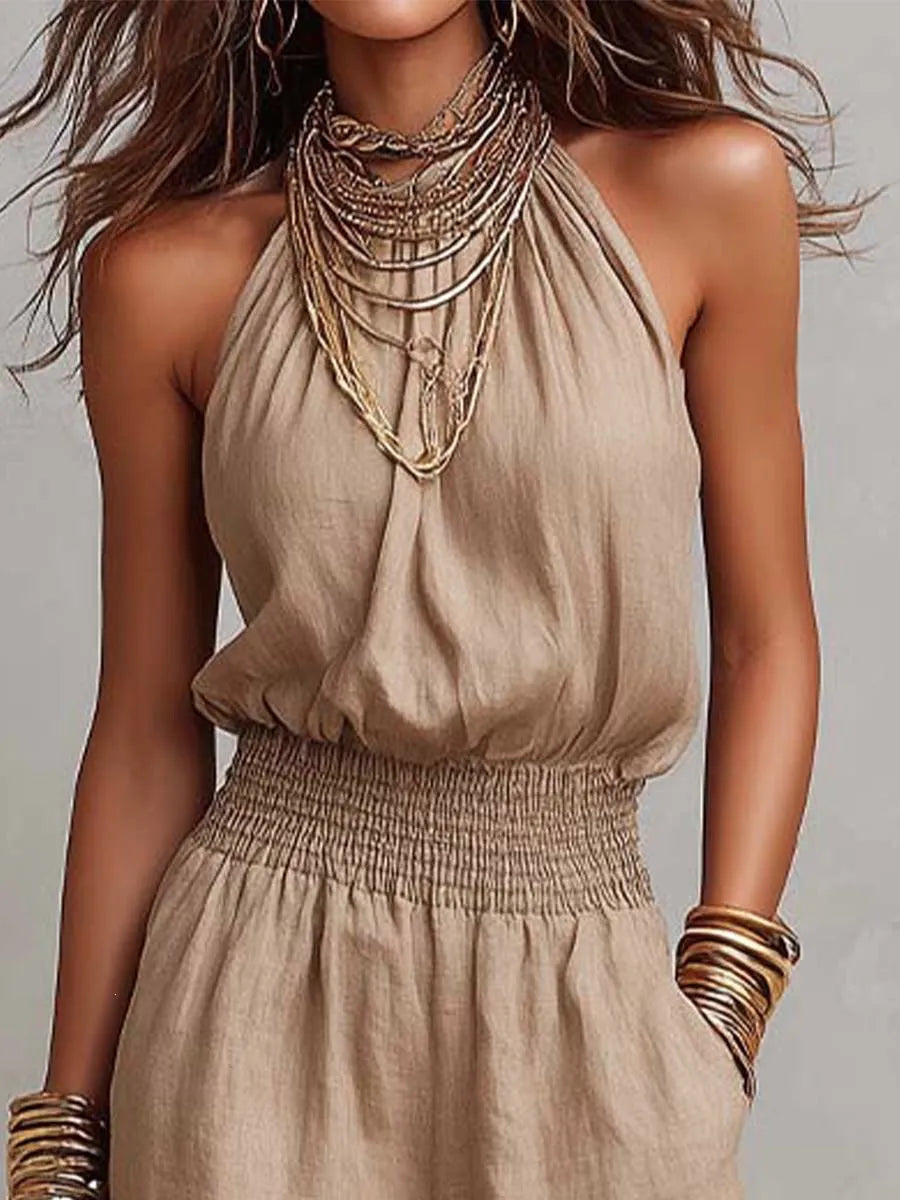 Summer holiday fashion: Sleeveless women's wide-leg jumpsuit with halter neck & smocked waist.