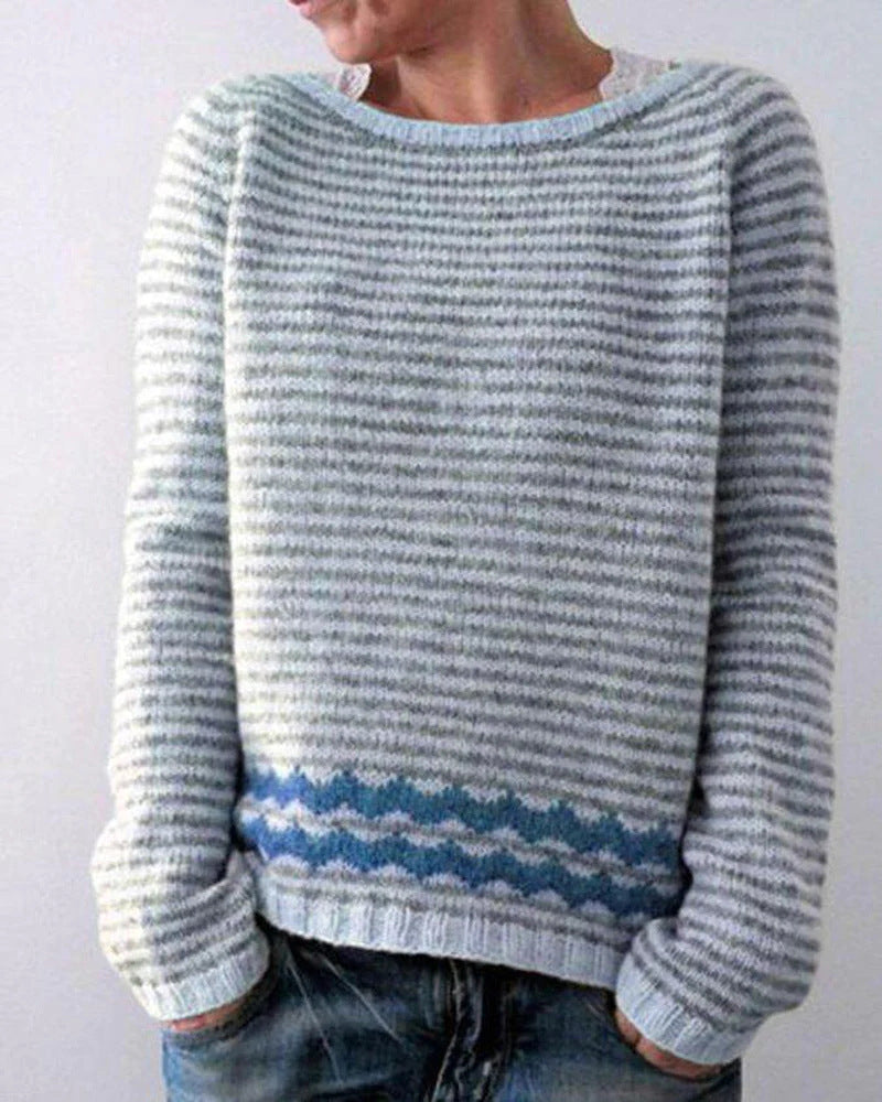 Women's soft gray Scandinavian style sweater, featuring a striped knit design. Cozy, long-sleeve pullover for winter fashion.