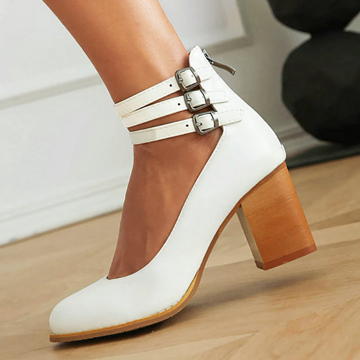 Elegant black block heels for women, featuring a secure ankle strap for stability and style.