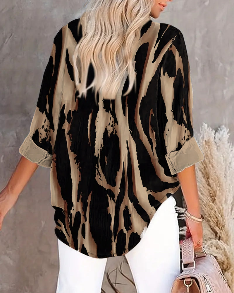 Close-up: Stand collar & unique irregular print on a women's long sleeve casual blouse.