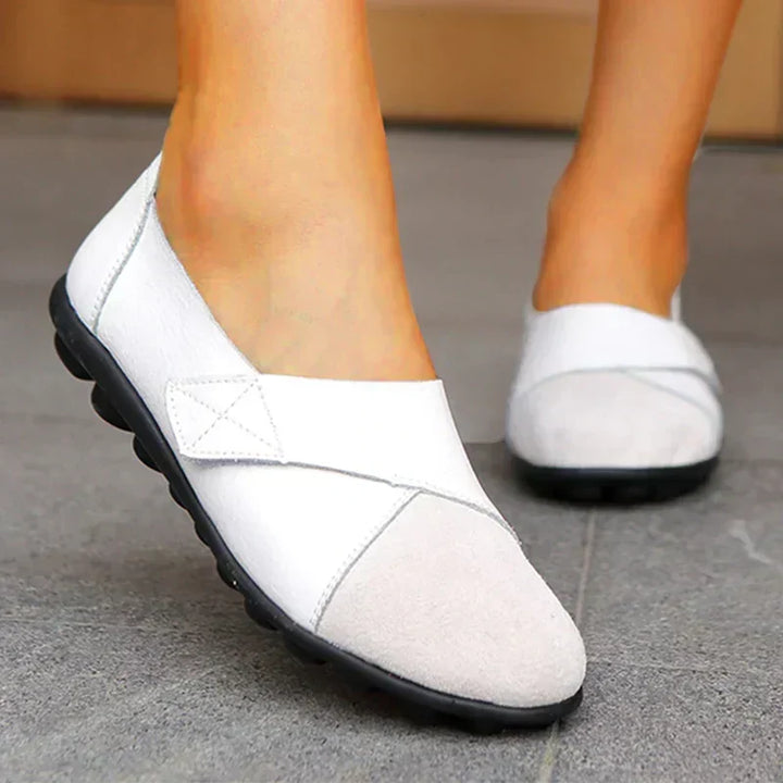 Stylish unisex casual slip-on flats with a comfortable round toe and decorative stitched panels.