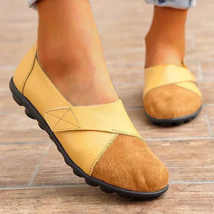 Versatile unisex flat slip shoes, round toe, stitched paneled detailing for everyday casual wear.