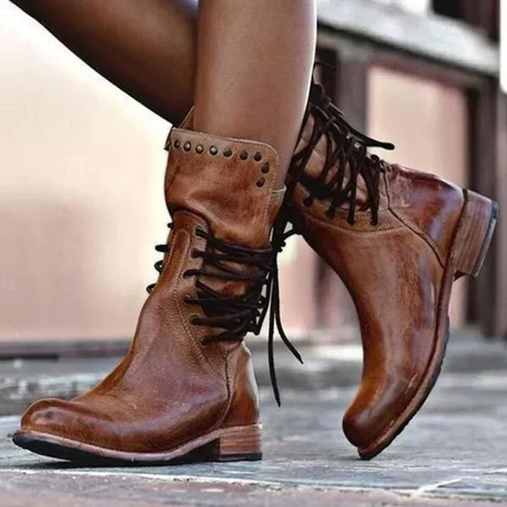 Women's black ankle-height lace-up boots with a sturdy block heel and studded detailing, perfect for fall fashion.