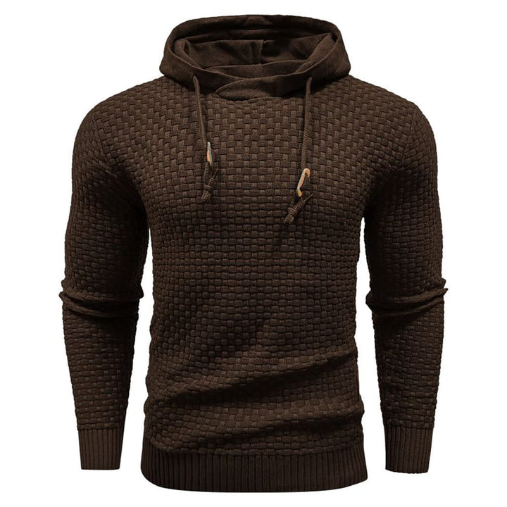 Relaxed man enjoying leisure time in a comfortable & warm men's waffle knit hoodie.