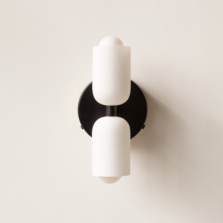 Vertical modern wall light, uplight downlight, casting ambient light for stylish interiors.