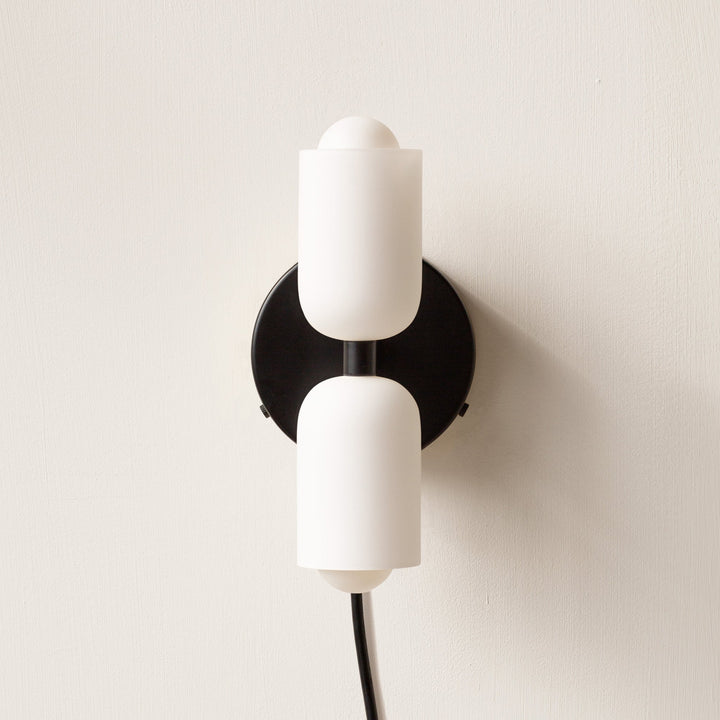 Elegant modern wall lamp, providing both uplight and downlight for subtle interior glow.