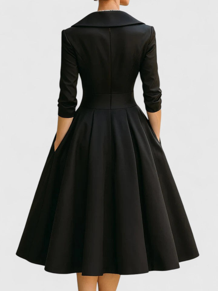 Back view of a sophisticated women's pleated flared midi dress, suitable as a formal or party dress.