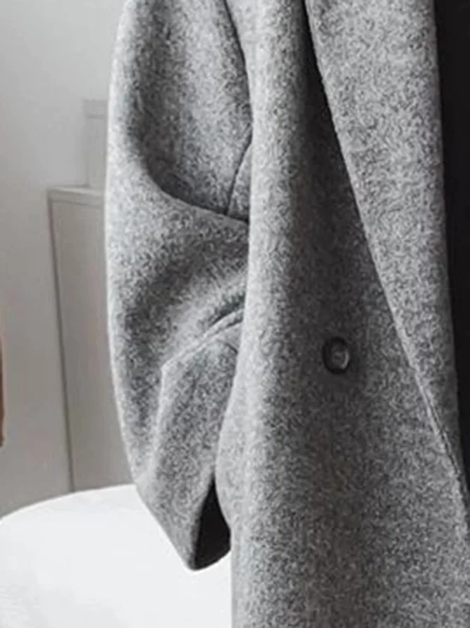 Chic women's long tailored overcoat in a classic style, ideal for elegant autumn & winter fashion. Ladies' outerwear.