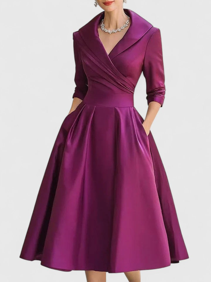 Women's elegant pleated flared midi dress styled with accessories, a perfect summer/autumn occasion dress.