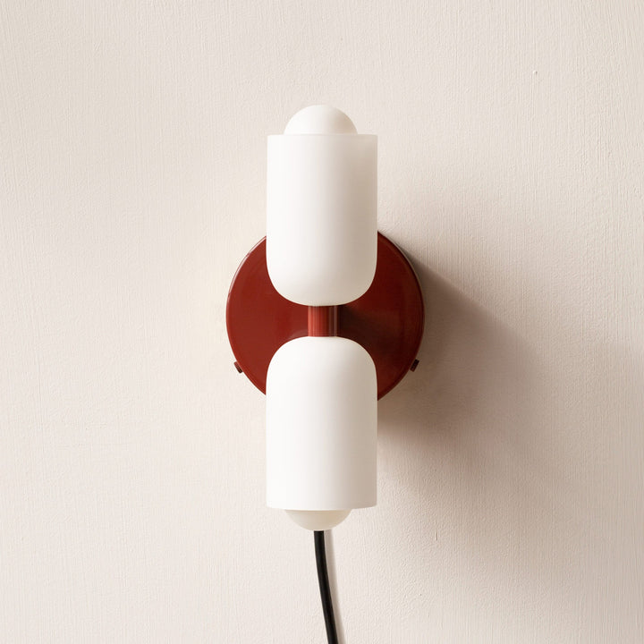Stylish wall mounted lamp, uplight and downlight, enhancing contemporary home decor.