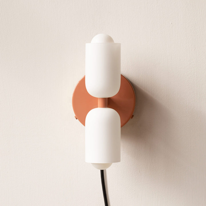 Chic wall sconce, uplight downlight feature, perfect for modern ambient living spaces.