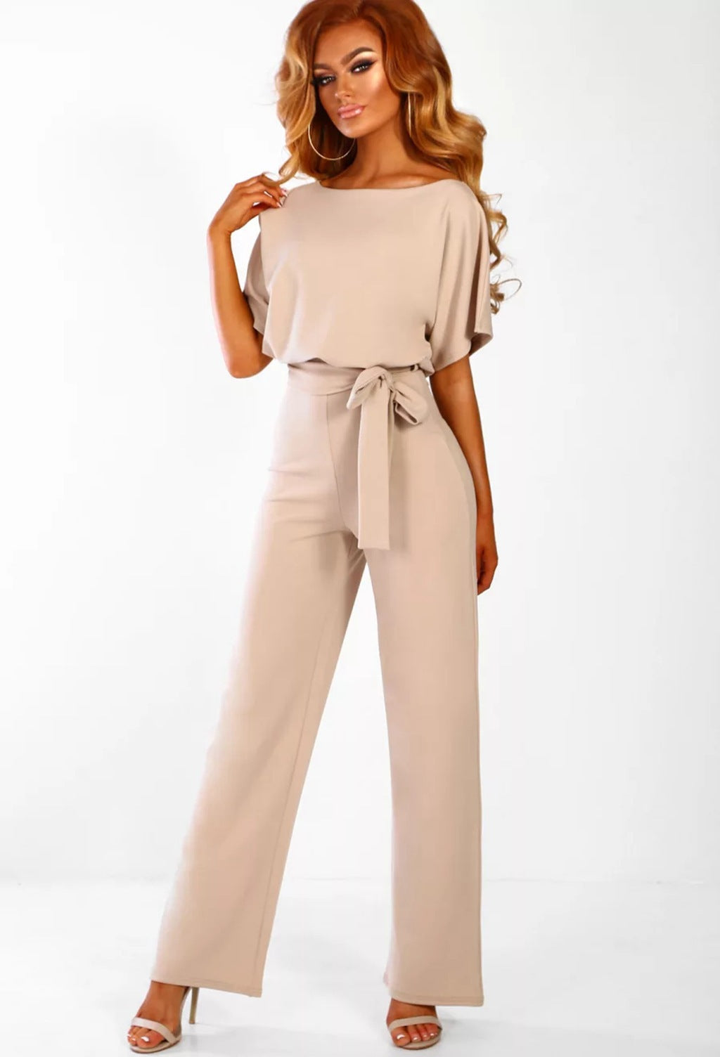 Flowing wide-leg women's jumpsuit with an elegant tied waist, offering comfort and style for any season.