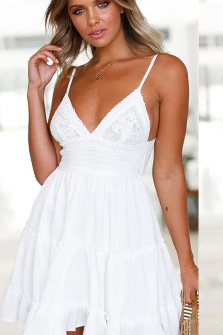 Flattering women's mini summer dress, spaghetti straps, open back, and a playful tiered skirt.