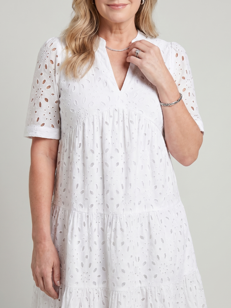 V-neck, short sleeve women's eyelet dress featuring a stylish tiered knee-length skirt; relaxed fit, perfect for summer.