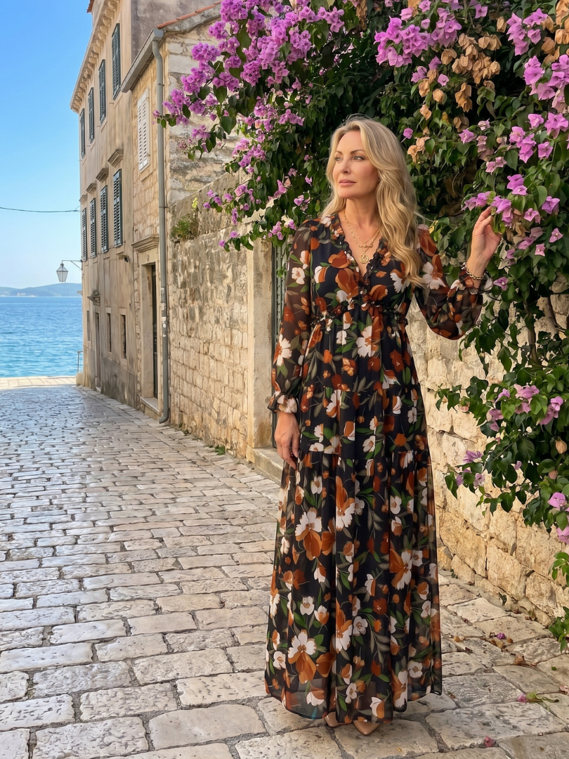 Women's long sleeve tiered maxi dress with all-over floral print, combining elegance and comfort.