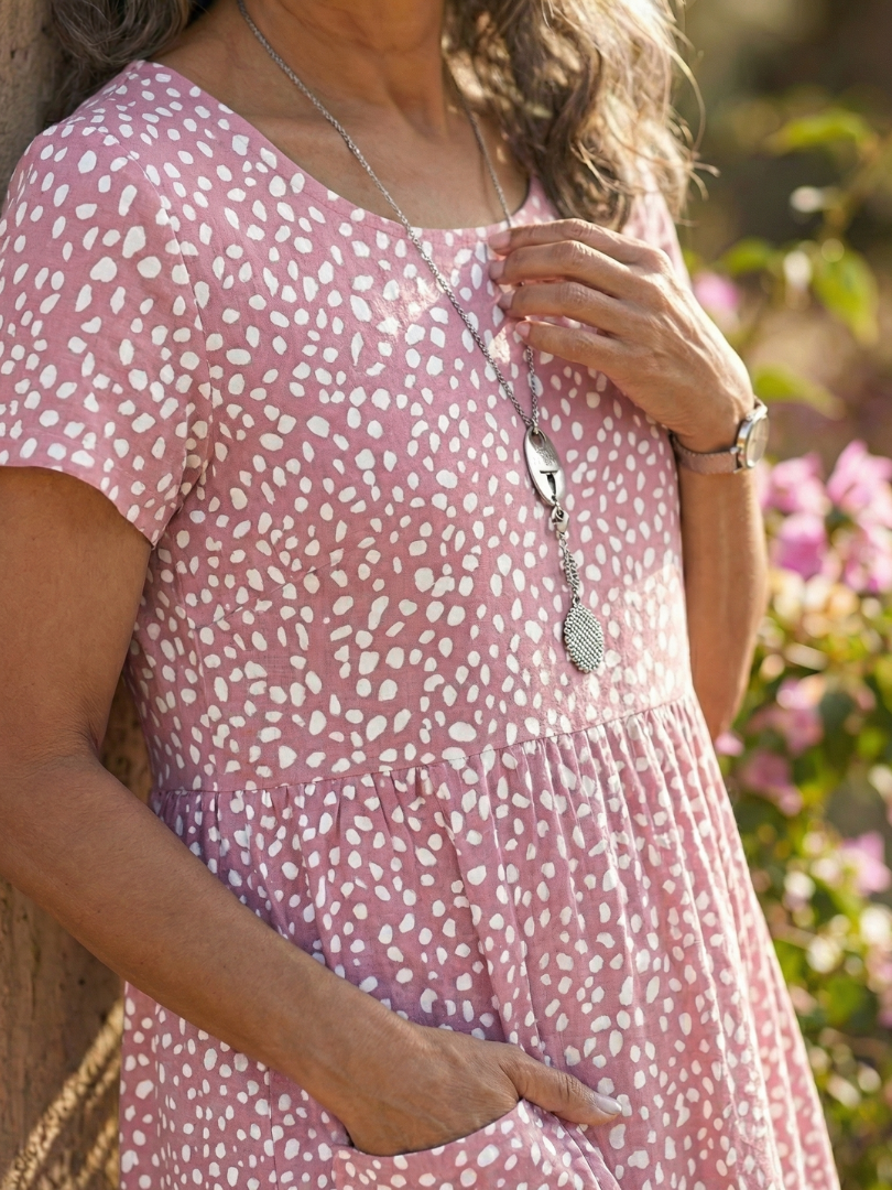 Round neck, short-sleeve women's dotted summer dress. Relaxed fit and knee length for ultimate comfort.