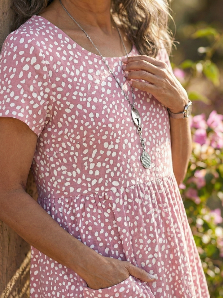 Round neck, short-sleeve women's dotted summer dress. Relaxed fit and knee length for ultimate comfort.