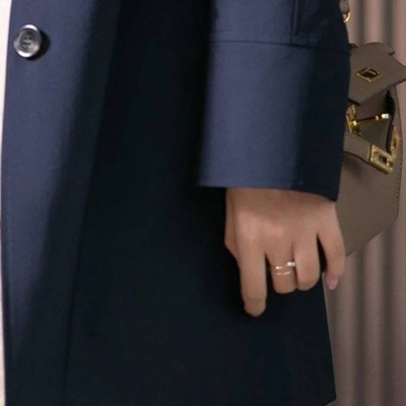 Elegant women's spring trench coat, a timeless piece of outerwear with a stylish tied waist.