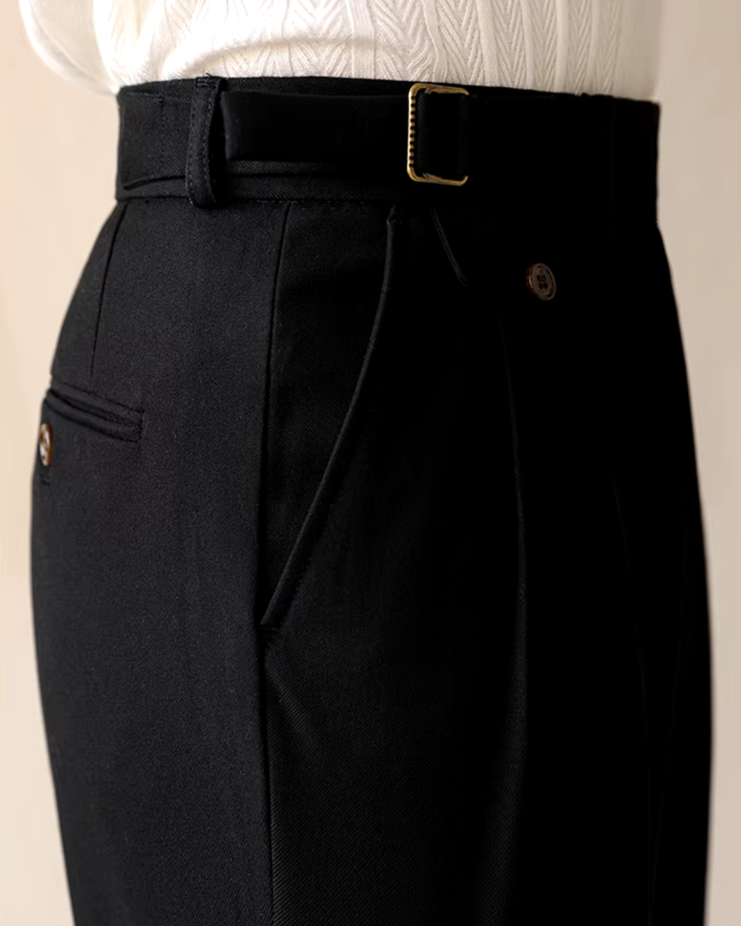 Detail of brown men's pleated trousers, straight fit, showing adjustable waist. Smart casual dress pants.