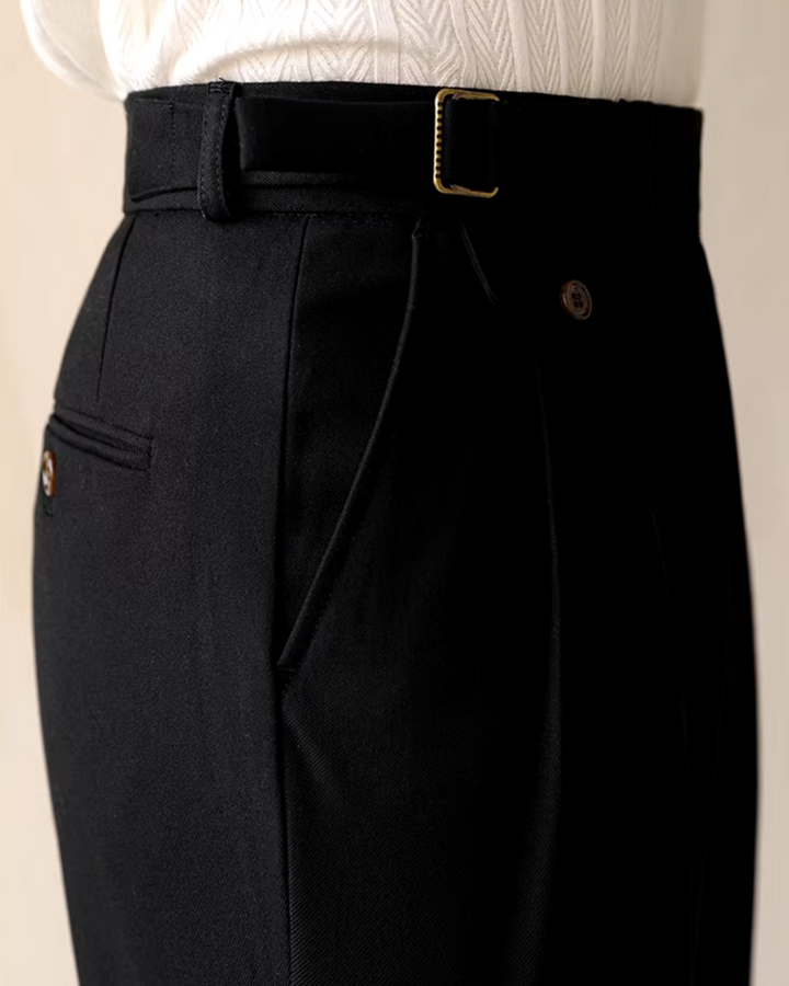 Detail of brown men's pleated trousers, straight fit, showing adjustable waist. Smart casual dress pants.